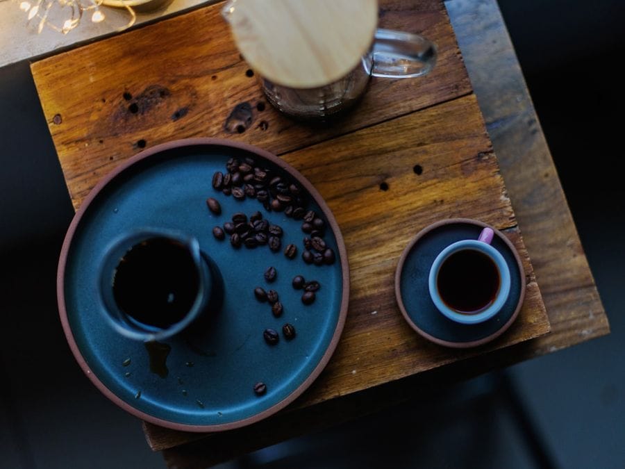 A coffee on a café table, seen from above — placeholder image.
