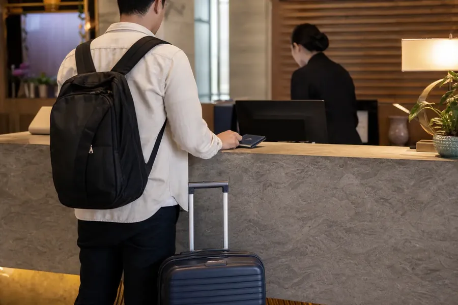 International traveler checking in at a Shanghai hotel front desk