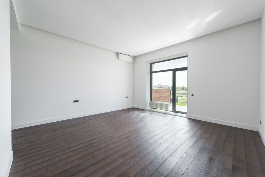 Empty bright apartment interior with parquet floor and balcony window — just-moved-in arrival visual (Pexels stock by Max Vakhtbovych).